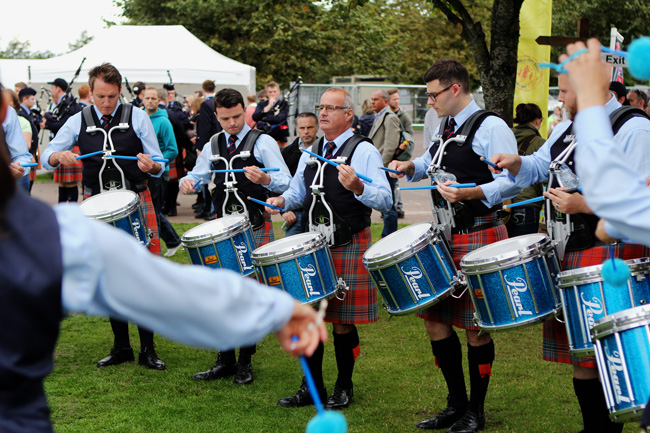 Jim Kilpatrick (centre) leading the Shotts & Dykehead Caledonia drum section before the 2014 World's Final. Blair Brown, now leading-drummer for the band, is to his left.