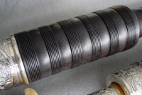 A drone piece in ebony, with characteristic peppering in the combing and short channels in the grain.