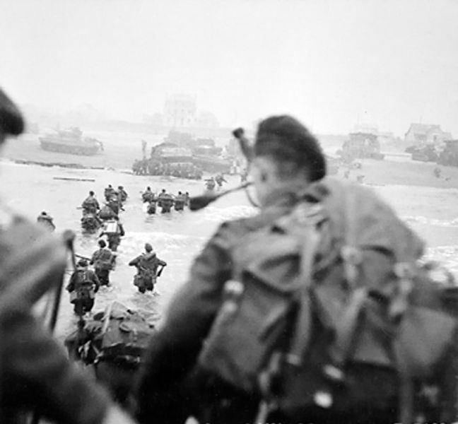 The now iconic photo of Lovat Scouts piper Bill Millin exiting his landing craft, storming the beaches of Normandy on D-Day, June 6, 1944.