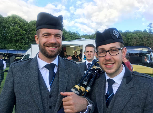 Inveraray & District Pipe-Sergeant Alasdair Henderson (right) enjoys post-contest victory.