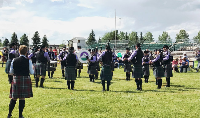 Adjudicator Ann Gray assesses the Grade 2 Rocky Mountain Pipe Band at the 2017 Red Deer Highland Games.
