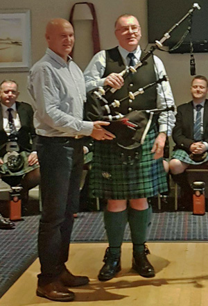 Willie McCallum presents a set of Duncan MacRae pipes to Kintyre Piping Society President John Brown.