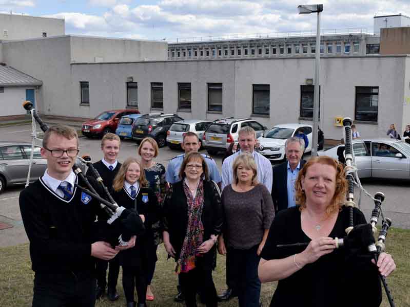 Front row L-R: Ronan Ruck, Lauren Caldwell, Councillor Sonya Warren, Lossiemouth High School teacher Heather Scott, piping teacher Fiona Caldwell. Back row L-R: Alexander Logan, Treasurer Janet Logan, Richard Bond, drumming teacher Douglas Caldwell, Councillor John Cowe.