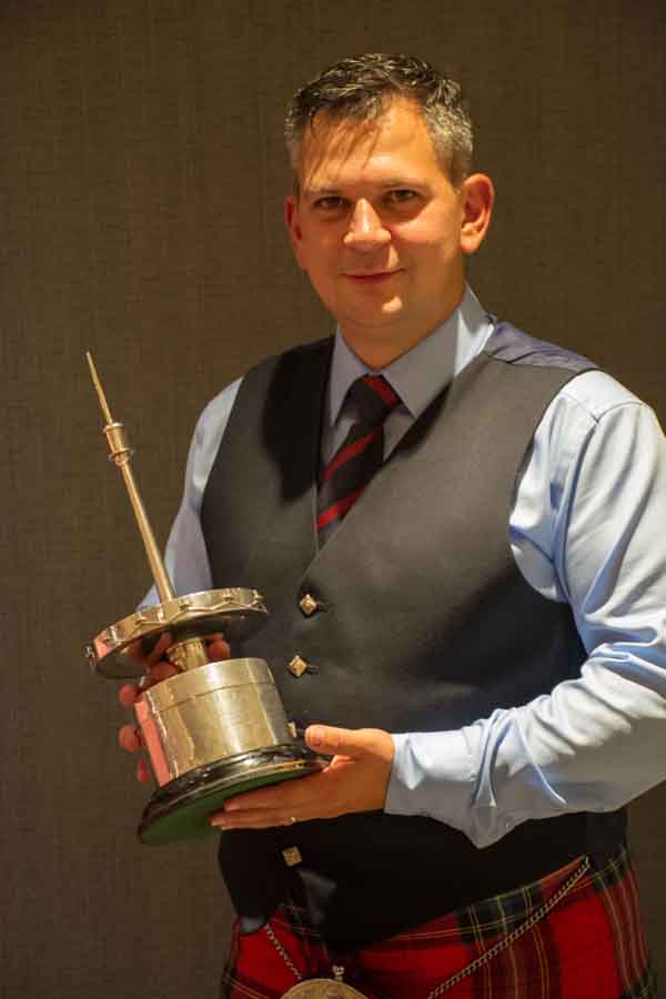 New Field Marshal Montgomery Pipe-Sergeant Matt Wilson with the 2018 World's trophy.