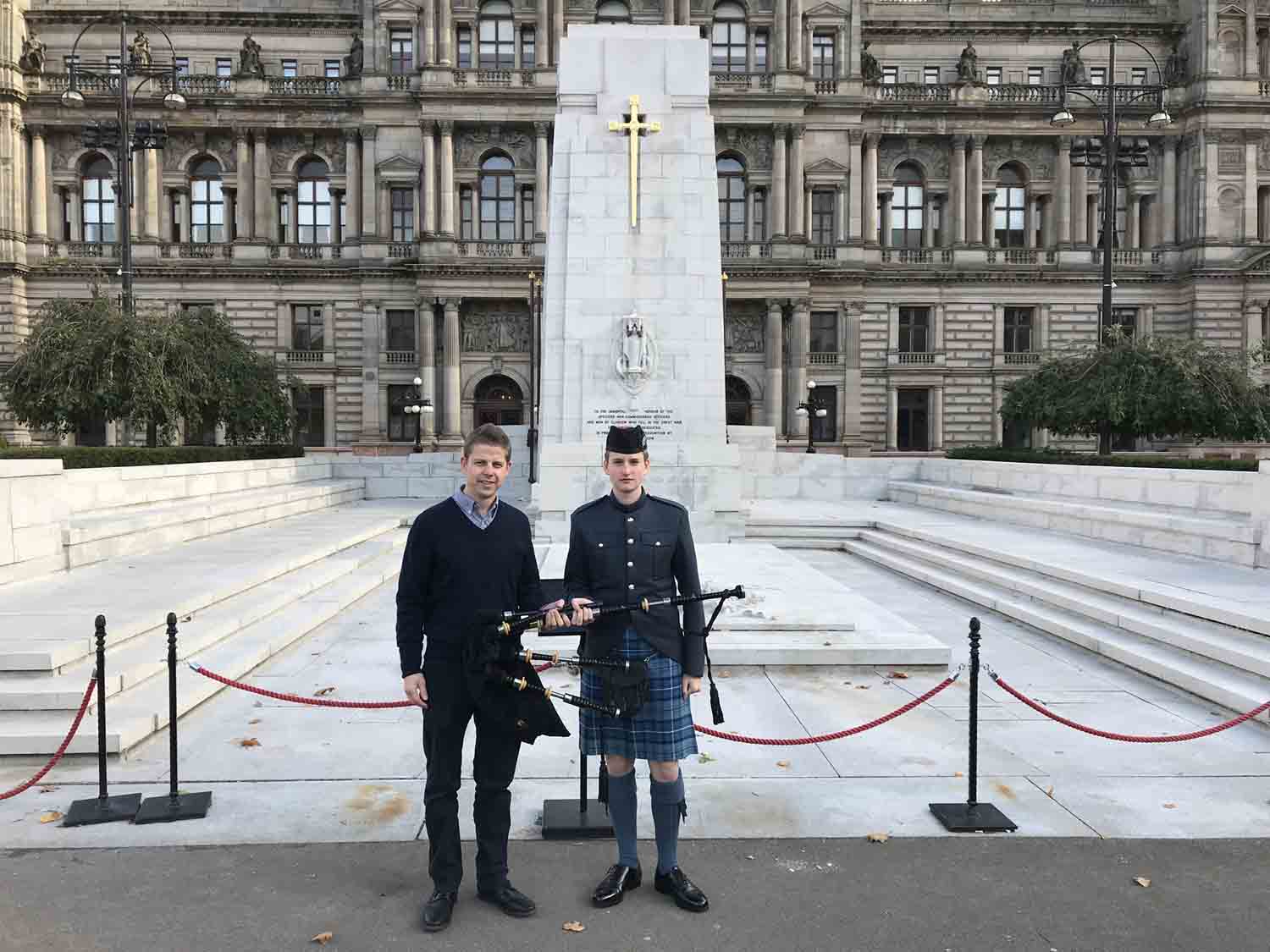 R.G. Hardie Director Alastair Dunn presents a new set of Henderson pipes to RAF Cadet Pipe-Major Fergus McClintock at the Cenotaph in Glasgow's city centre.