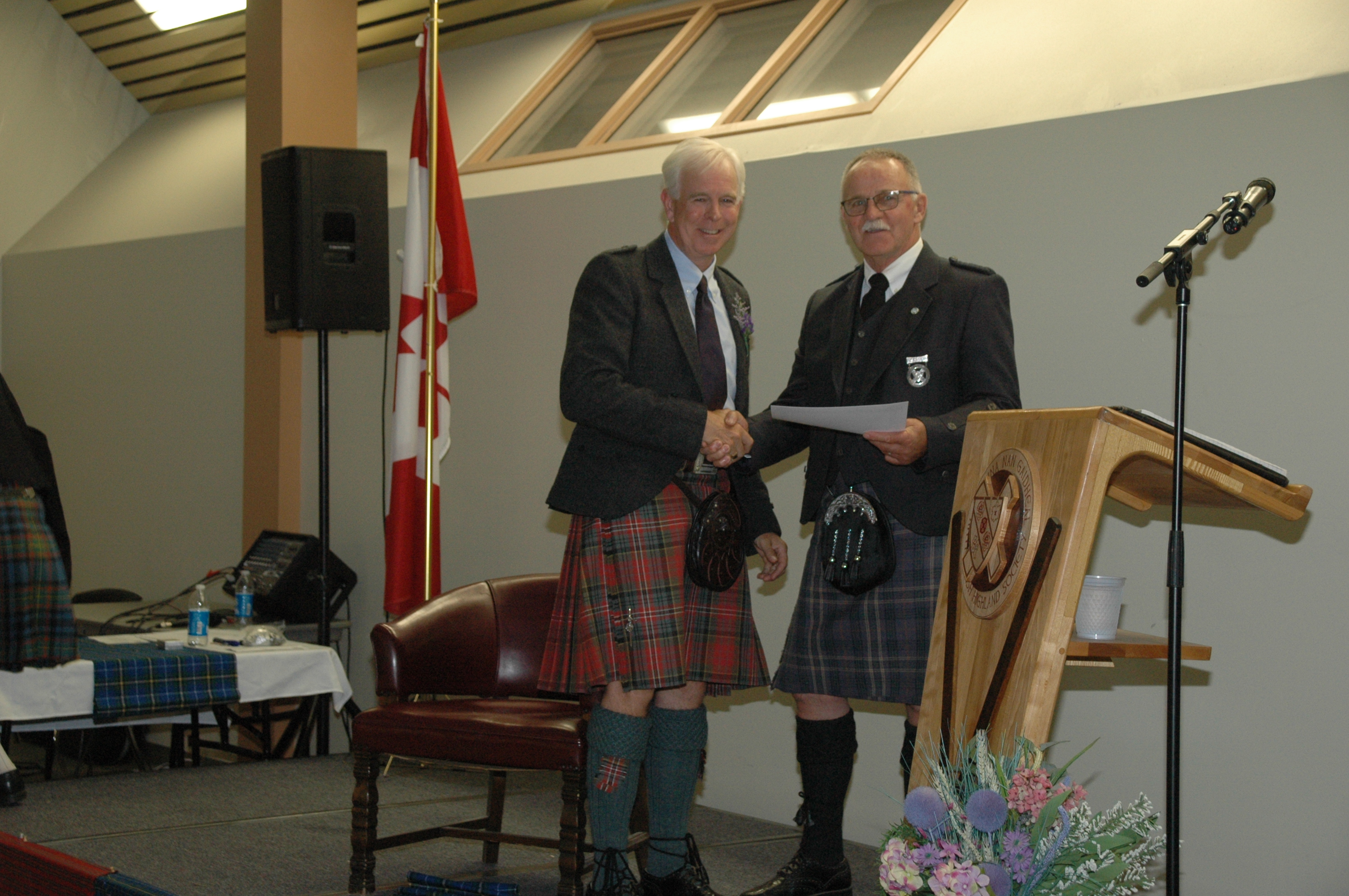 Doug Boyd receiving Hall of Fame induction certificate from Robert Cochrane, President of the Antigonish Highland Society.