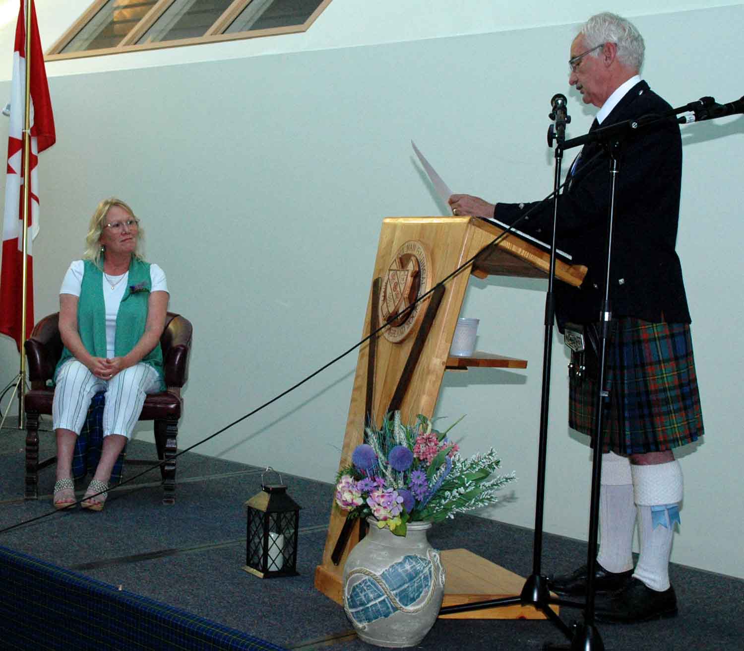 Beverley Gandy accepts Bruce Gandy's induction from Danny Gillis, Chair of Piping and Drumming and Chair of Hall of Fame Committee.
