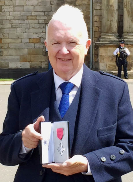 Mervyn Herron at Holyrood Palace with his MBE medal.