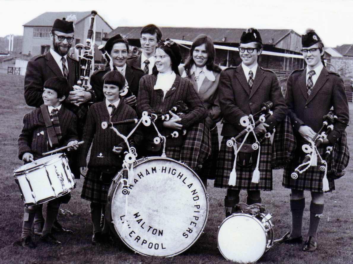 The Graham Highland Pipers, at the 1975 Shotts Highland Games. L-R: Tom Graham, Gordon Graham, Andrew Graham, Peggy Graham, Richard Graham, Janet Graham, Christene Graham, Ian Graham and David Graham.