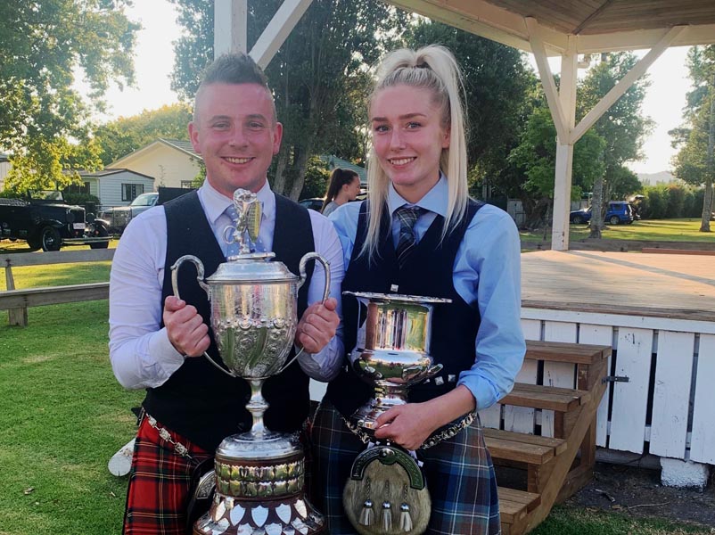 Liam Kernaghan and Anna Smart with their overall trophies from the 2020 Waipu Highland Games.