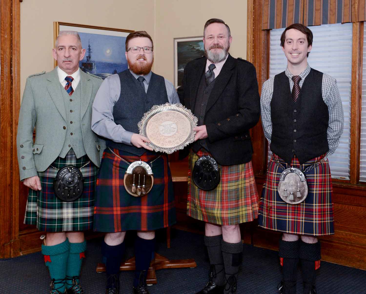 Amateur A Piobaireachd winner Liam Melville receiving the Pipe-Major George D. Buchanan Memorial Trophy. Also pictured, Branch 2nd Vice President Allan MacKenzie (left), and Branch President Jacob Dicker (right).