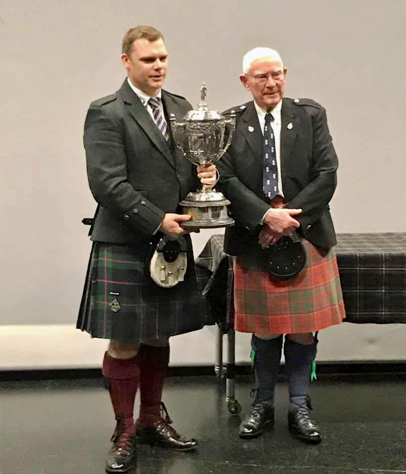 Stuart Easton (left) with the Brown Cup, along with judge John Hanning.