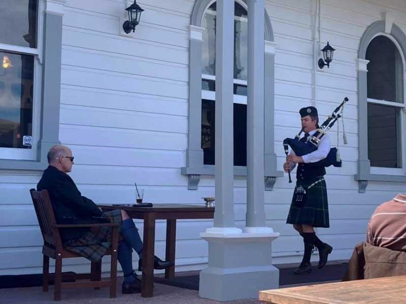 Willie Rowe doing the business for judge Brian Switalla at the 2020 Northcote Invitational Solo Piping Competition on the steps of the Northcote Tavern in Auckland.