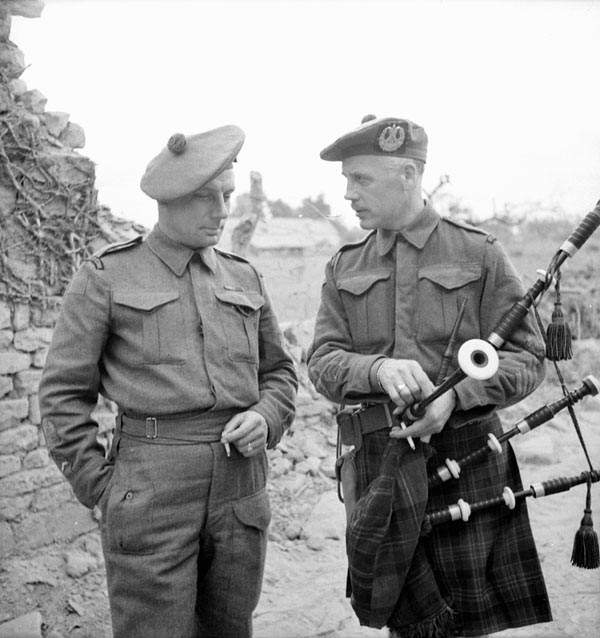 Regimental Sergeant-Major L.D. Burnet and Pipe-Major Samuel Scott of the Cameron Highlanders of Ottawa (M.G.), near Caen, France, July 15, 1944.